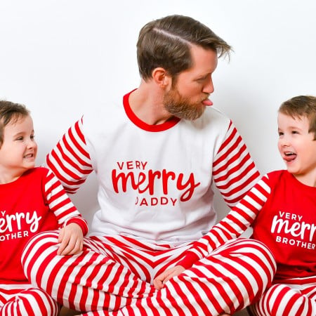 Boys wearing Very Merry Brother shirts and dad wearing Very Merry Daddy shirt